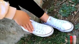 Asian girl sprains ankle white socks