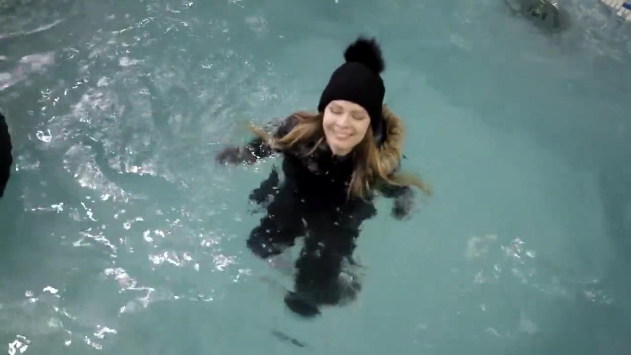 Girl swimming pool with winter clothes